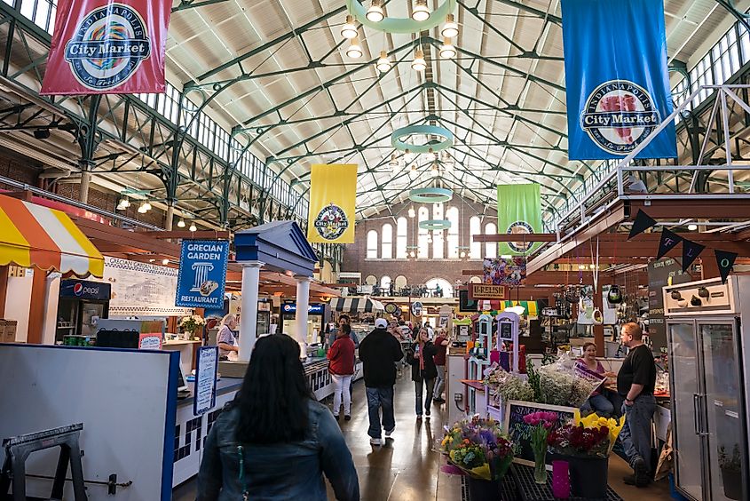 People walk past food stalls and shops inside City Market in Indianapolis, Indiana. 