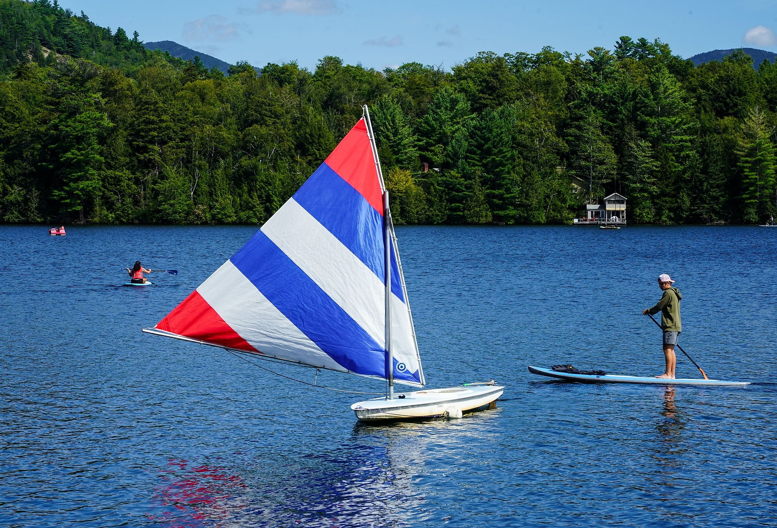 Water boarder enjoys summer day on Mirror Lake in Lake Placid, New York. Image credit Leonard Zhukovsky via Shutterstock