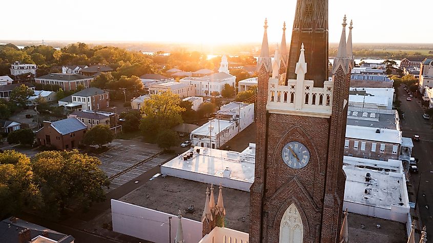 Sunset light shines on a historic church and the downtown landscape in Natchez, Mississippi