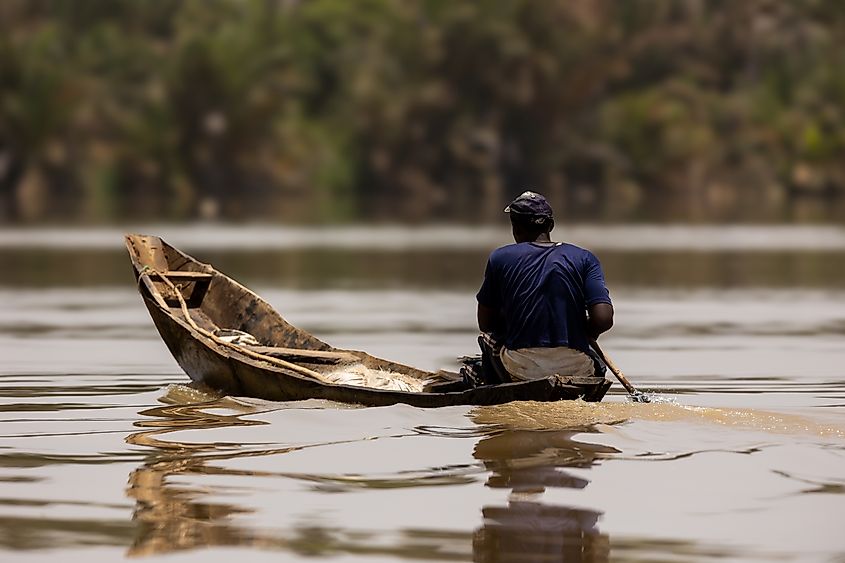 A man fishing in the River Gambia. Image credit Carlos Pereira M via Shutterstock.